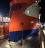 Orange, White and blue offshore vessel in drydock