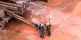 Two persons seen from above working in the dry dock
