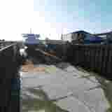 A dry dock with a vessel high and dry