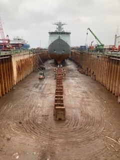 A navy vessel inside a dry dock