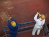 Hand scraping a ship hull