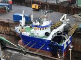 Blue fishing vessel in dock