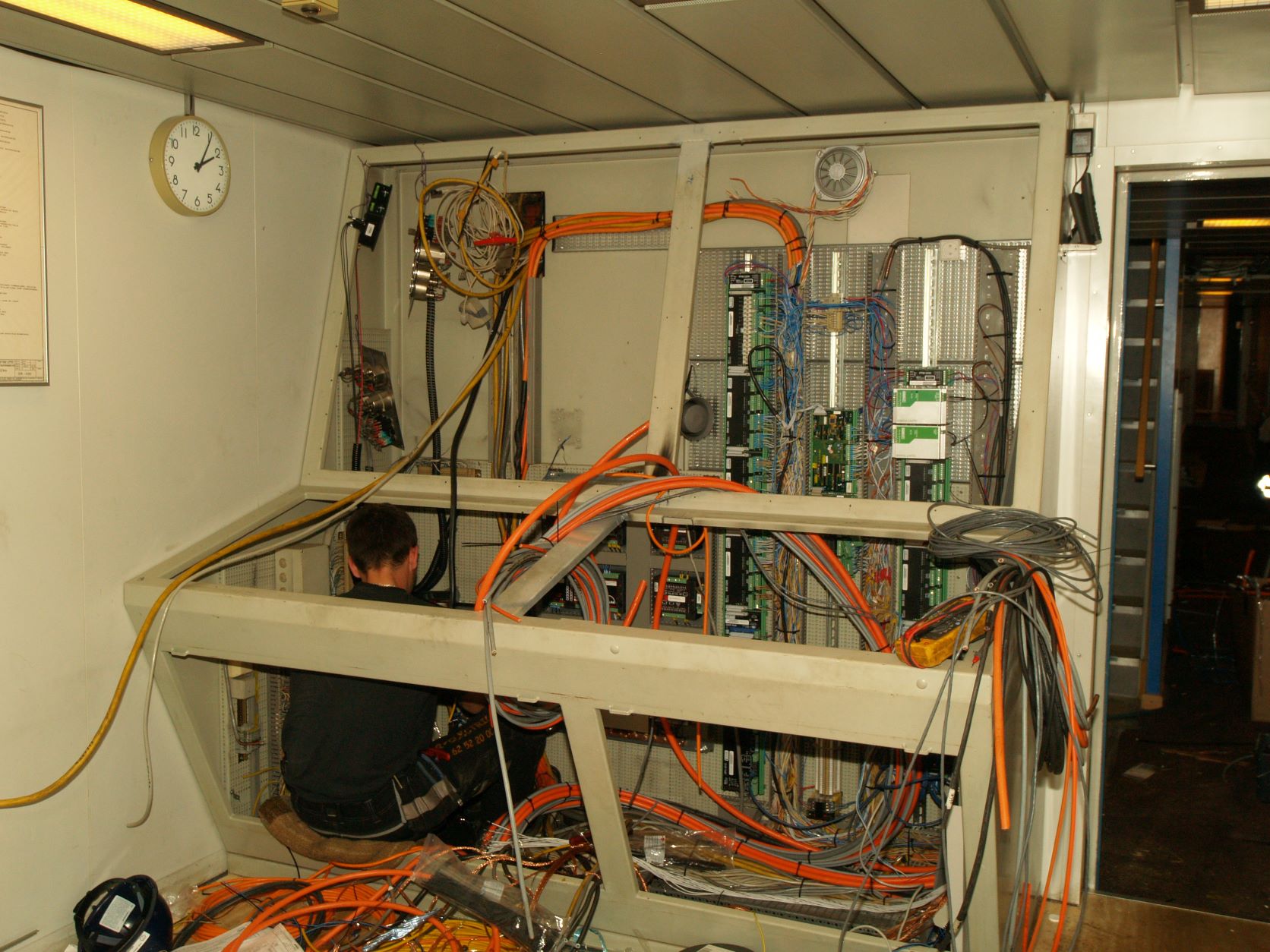 Man doing electrical work inside a switchboard