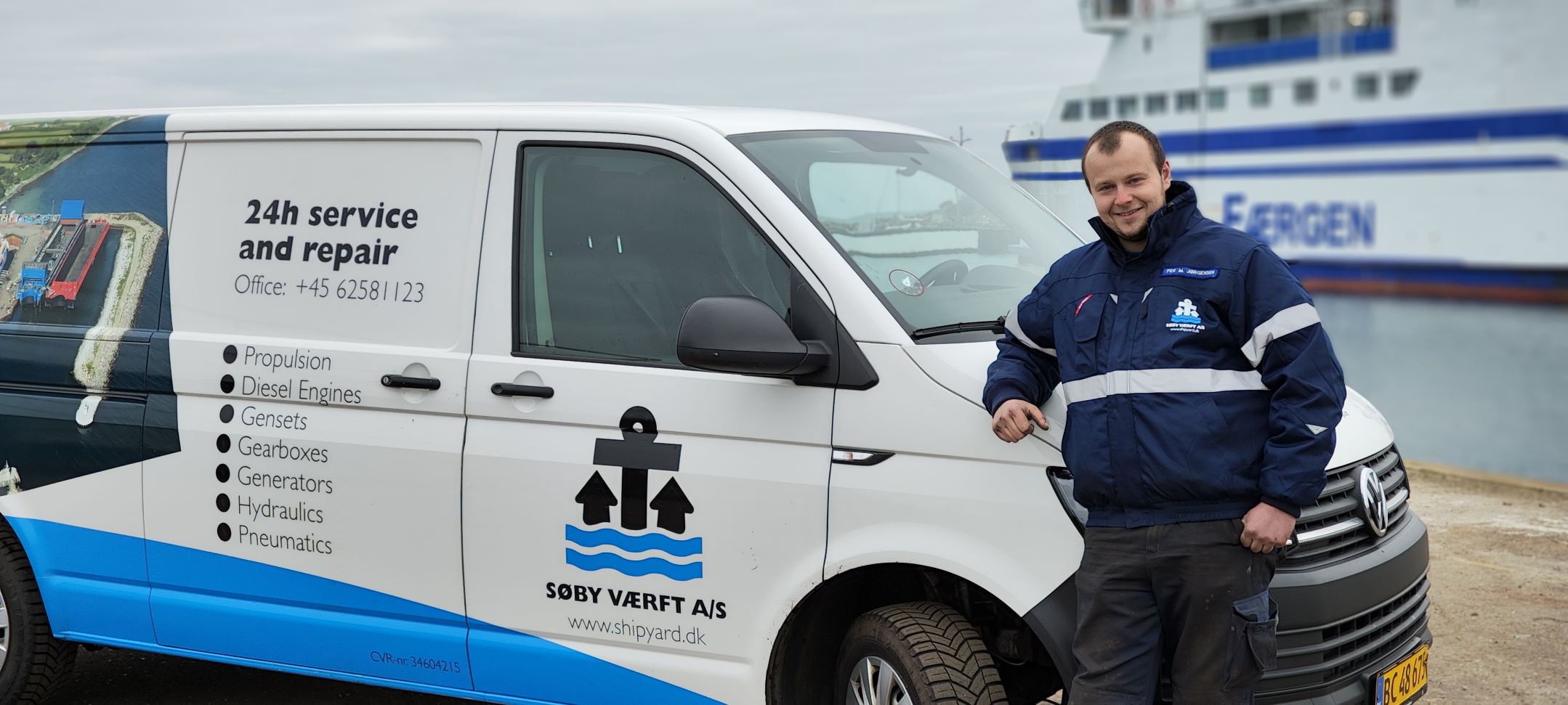 A man in front of the Søby Shipyard van
